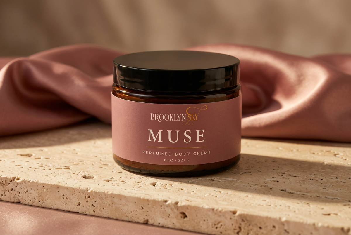 Muse Body Crème editorial lifestyle concept on ivory stone with rose silk